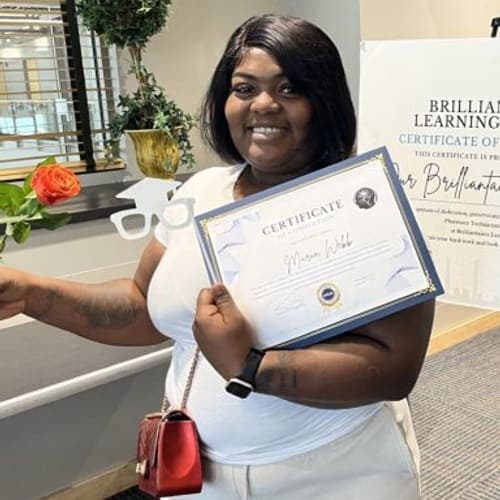 A Brilliantaires graduate celebrating with her certificate