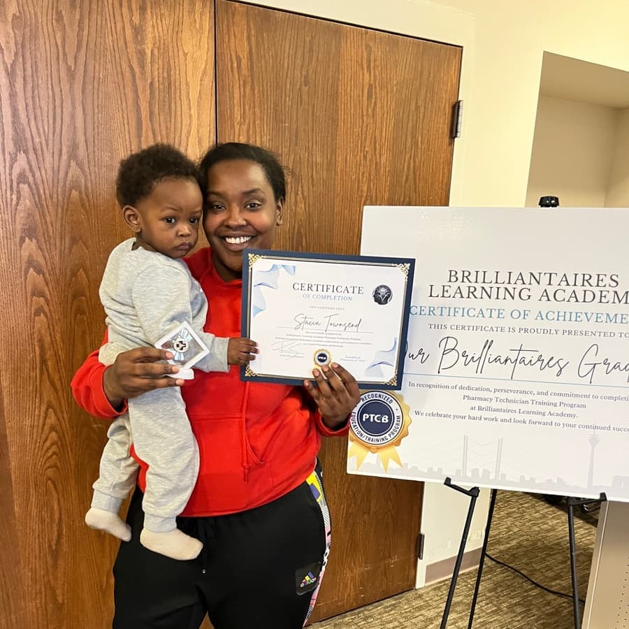 A Brilliantaires graduate celebrating with her certificate