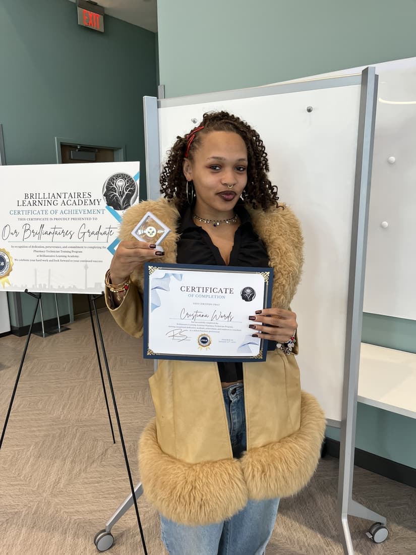 A Brilliantaires graduate holding her certificate