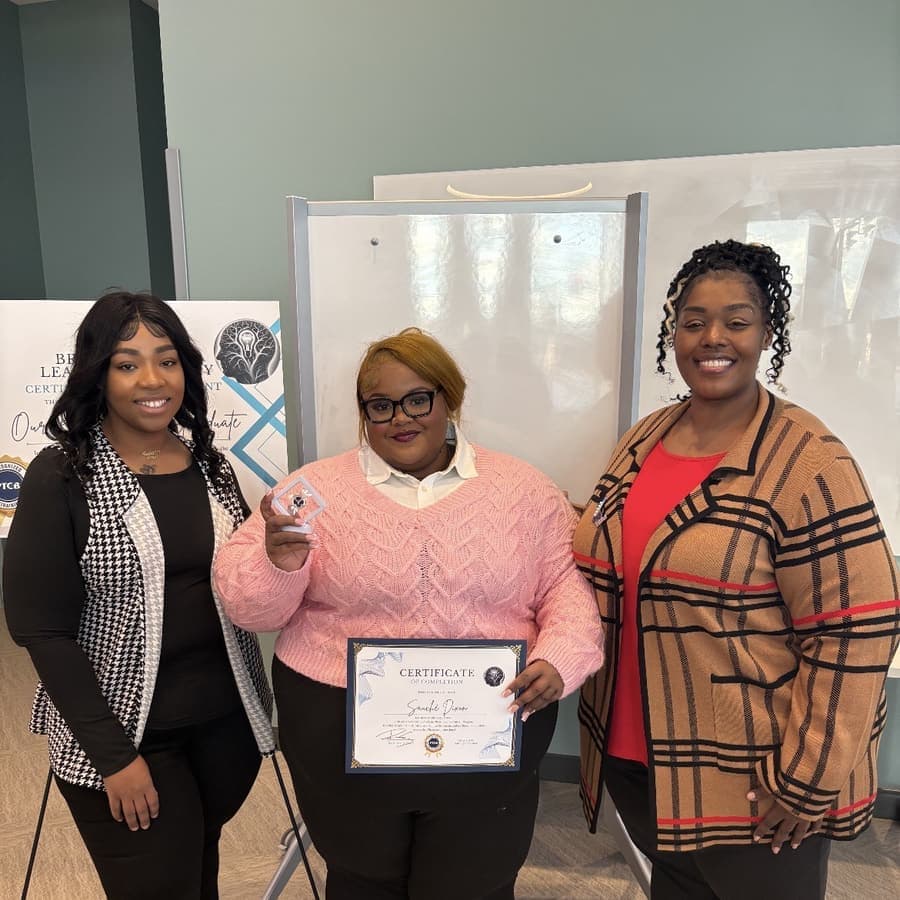 A Brilliantaires graduate holding her certificate