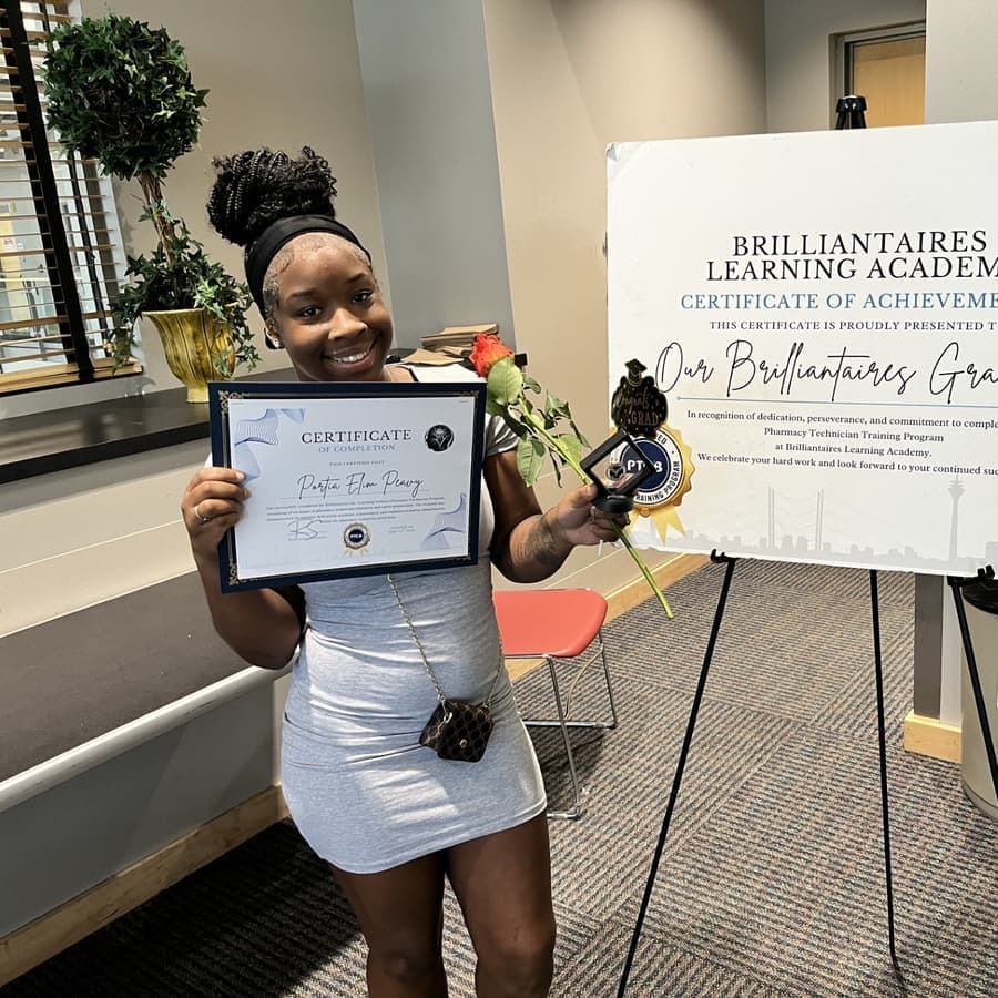 A Brilliantaires graduate holding her certificate