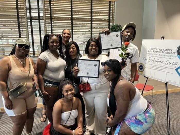 Brilliantaires graduates holding their certificates